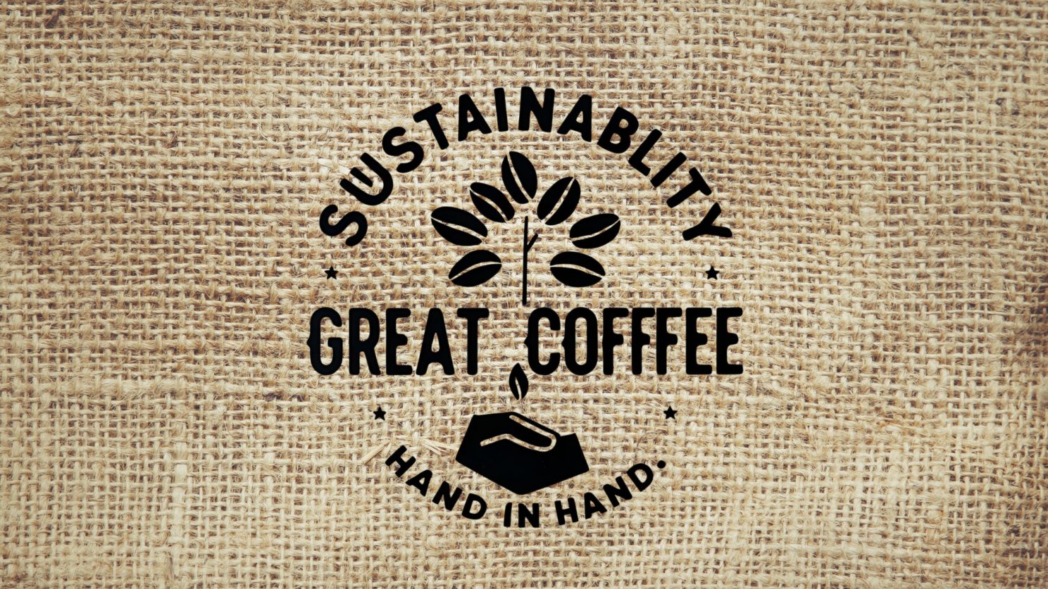 A stamped badge reading “Sustainability and great coffee, hand in hand” on a hessian coffee sack
